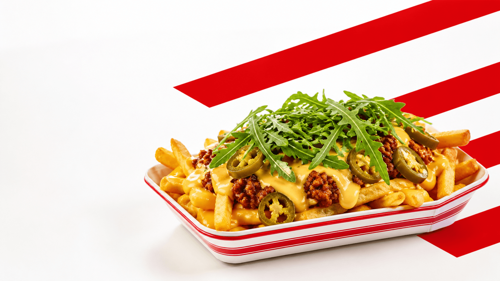 Loaded Fries mit Käsesauce, Chili, Jalapenos und Rucola